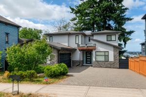 a white house with a brick driveway at 5-Star Luxury and comfortable home in New Westminster