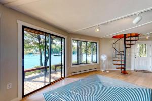 a bedroom with a view of the water at Unique oceanfront home with a deck, tons of natural light, & amazing views in Wiscasset +15 photos