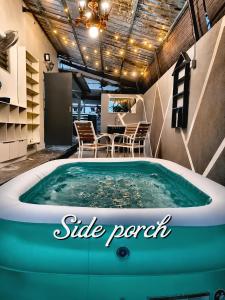 a hot tub in a room with a table and chairs at Bergstein Taiping in Taiping