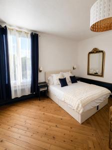 a bedroom with a white bed and a large window at Chambre Oolong Familiale in Cormeilles
