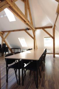 a table and chairs in a room with wooden floors at CasaBlanca Biały Dom in Borne Sulinowo