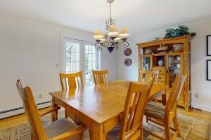 a dining room with a wooden table and chairs at Gorgeous, walkable home with water view, deck & washer/dryer - snowbird-friendly in Camden
