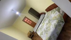 a small bedroom with a bed and a window at Гостевой дом Арай in Bosteri +1 photo