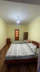 a bedroom with a large bed in a room at Гостевой дом Арай in Bosteri