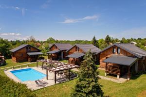 an aerial view of a lodges with a pool and a house at Timber Fairies in Slunj