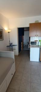 a kitchen with a white refrigerator and a stove at Apartmani Šikić Metajna in Metajna