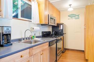 a kitchen with a sink and a stove at Woodland Home near Long Pond w/ Spacious Living Area, Full Kitchen & Deck in Somesville