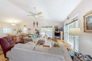 a living room with two couches and a table at Inviting dog-friendly home with firepit & Ping-Pong - near Acadia National Park in Ellsworth