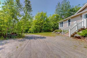 a home with a driveway next to a house at Inviting dog-friendly home with firepit & Ping-Pong - near Acadia National Park in Ellsworth