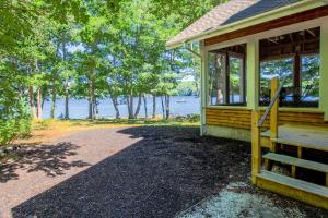 a porch of a house with a view of the water at Private waterfront home with large deck & deep water dock in Georgetown