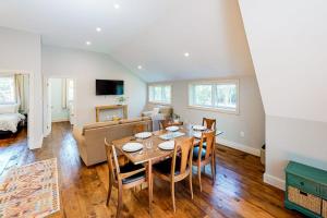 a living room with a table and a couch at Cozy and modern hideaway - walk to the beach - fast WiFi & washer/dryer in Marlboro