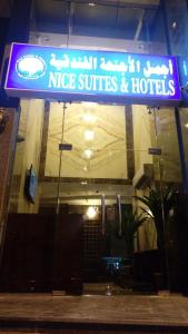 a neon sign for a nice suites and hotel at Nice Suites & Hotels in Makkah