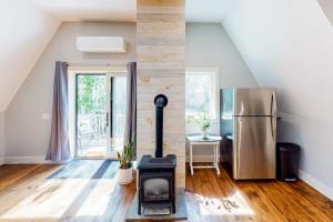 a living room with a stove and a refrigerator at Cozy and modern hideaway - walk to the beach - fast WiFi & washer/dryer in Marlboro +13 photos