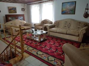 a living room with two couches and a table at AmedaPm in Gjirokastër