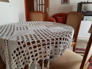 a white lace table with chairs in a room at AmedaPm in Gjirokastër +1 photo