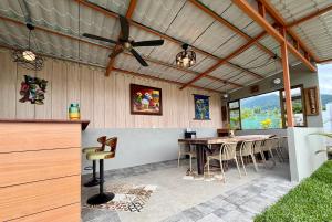 a patio with a table and a ceiling fan at Kokoro Garden in Fortuna