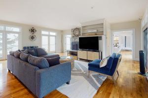 a living room with two couches and a tv at Spectacular oceanfront retreat with amazing views, sunroom & washer/dryer in Georgetown