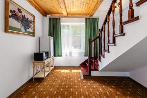 a room with a staircase with a television and a window at Tau Shyraq in Almaty