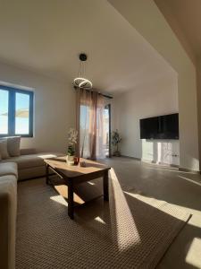 a living room with a couch and a table at Bella Villa in Proástion