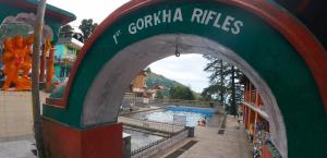 an archway to a swimming pool at a resort at RCA Homestay in Dharmsāla