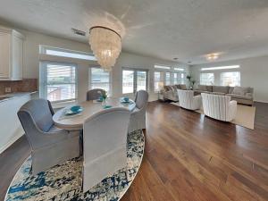 a dining room and living room with a table and chairs at West Bay Getaway in Galveston