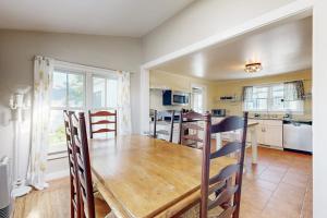 a dining room with a wooden table and a kitchen at Beautiful Retreat | Home Office | Walk 5 MInutes to Main Street in Wiscasset