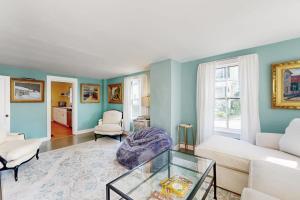 a living room with a white couch and a glass table at Beautiful Retreat | Home Office | Walk 5 MInutes to Main Street in Wiscasset