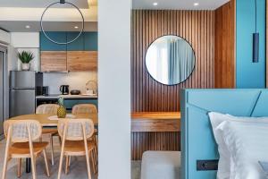 a kitchen and a dining room with a table and chairs at Merivian Seaside Suites in Kanali