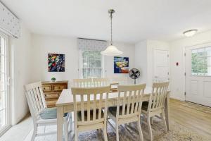a dining room with a table and chairs at Secluded Dog-Friendly Getaway w/ Free WiFi, Private Washer/Dryer, Furnished Deck in Southport