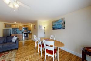 a kitchen and living room with a table and chairs at Stylish Condo at Sheepscot Harbor Resort w/Free WiFi, River Views, & Balcony in Edgecomb