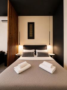 a bedroom with a large bed with two towels on it at Cabana Condo in Ierapetra