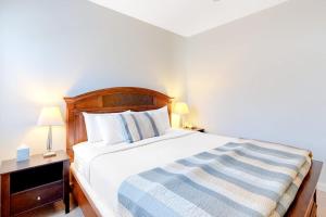 a bedroom with a bed and a nightstand with two lamps at Cozy & Clean Second-Story Suite w/ Kitchenette & Free WiFi - Walk to the Harbor in Northeast Harbor
