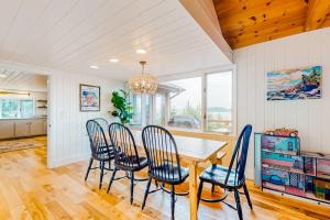 a dining room with a table and chairs at Renovated oceanfront home with stunning view & pebbly beach - snowbird-friendly in Saint George