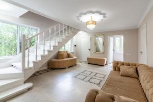 a living room with a couch and a staircase at Tau Shyraq in Almaty