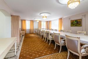 a long conference room with a long table and chairs at Tau Shyraq in Almaty