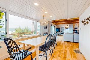 a dining room with a table and chairs at Renovated oceanfront home with stunning view & pebbly beach - snowbird-friendly in Saint George