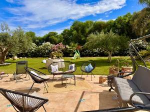 a patio with chairs and a table and a playground at Le maioliche allo Stagnone kite in Marsala