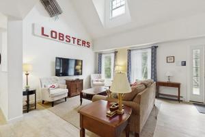 a living room with a couch and a table at Secluded Dog-Friendly Getaway w/ Free WiFi, Private Washer/Dryer, Furnished Deck in Southport