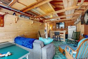 a living room with a couch and a table at Charming Boothbay Harbor cottage with partial AC, full kitchen, and sun room in Boothbay Harbor