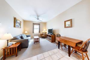 a living room with a couch and a table at Lovely downtown Northeast Harbor suite near the water and near Acadia in Northeast Harbor