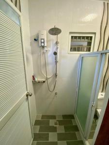 a shower stall in a bathroom with a shower at Hermosa Traveler's Corner in Culis