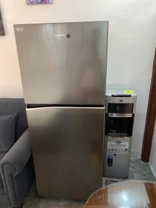 a stainless steel refrigerator in a living room at Hermosa Traveler's Corner in Culis