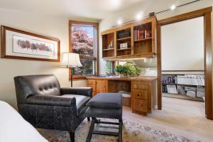 a bedroom with a desk and a chair and a desk and a chair at Elegant ocean view home with breathtaking views, private hot tub & large deck in Rockport