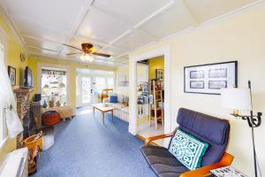 a living room with a couch and a chair at Dog-friendly Fisher Hill home with patio and wood stove - walk to the harbor in Boothbay Harbor
