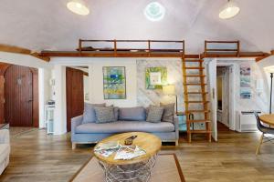 a living room with a couch and a bunk bed at Geodesic Dome w/ Riverfront Deck, Lovely Views, & High-Speed WiFi - Dogs Welcome in Boothbay