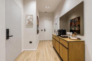 a hallway with a wooden dresser in a room at Via Mare Jacuzzi Suites by PS in Durrës