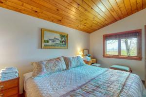 a bedroom with a bed and a wooden ceiling at Beautiful hilltop home with deck & view of Penobscot Bay - near festivals & more in Rockport +23 photos