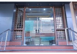 a large glass window on a building with stairs at Shree Sanmat Guest House in Gwalior