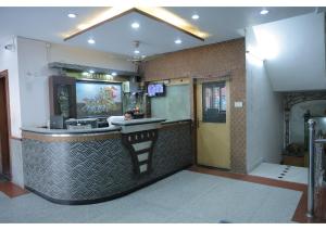 a bar in a restaurant with a counter at Shree Sanmat Guest House in Gwalior