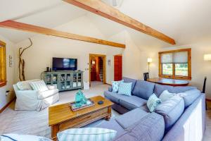 a living room with a blue couch and a table at Dog-friendly beach house with WiFi, private washer/dryer, deck, beautiful views in Bristol